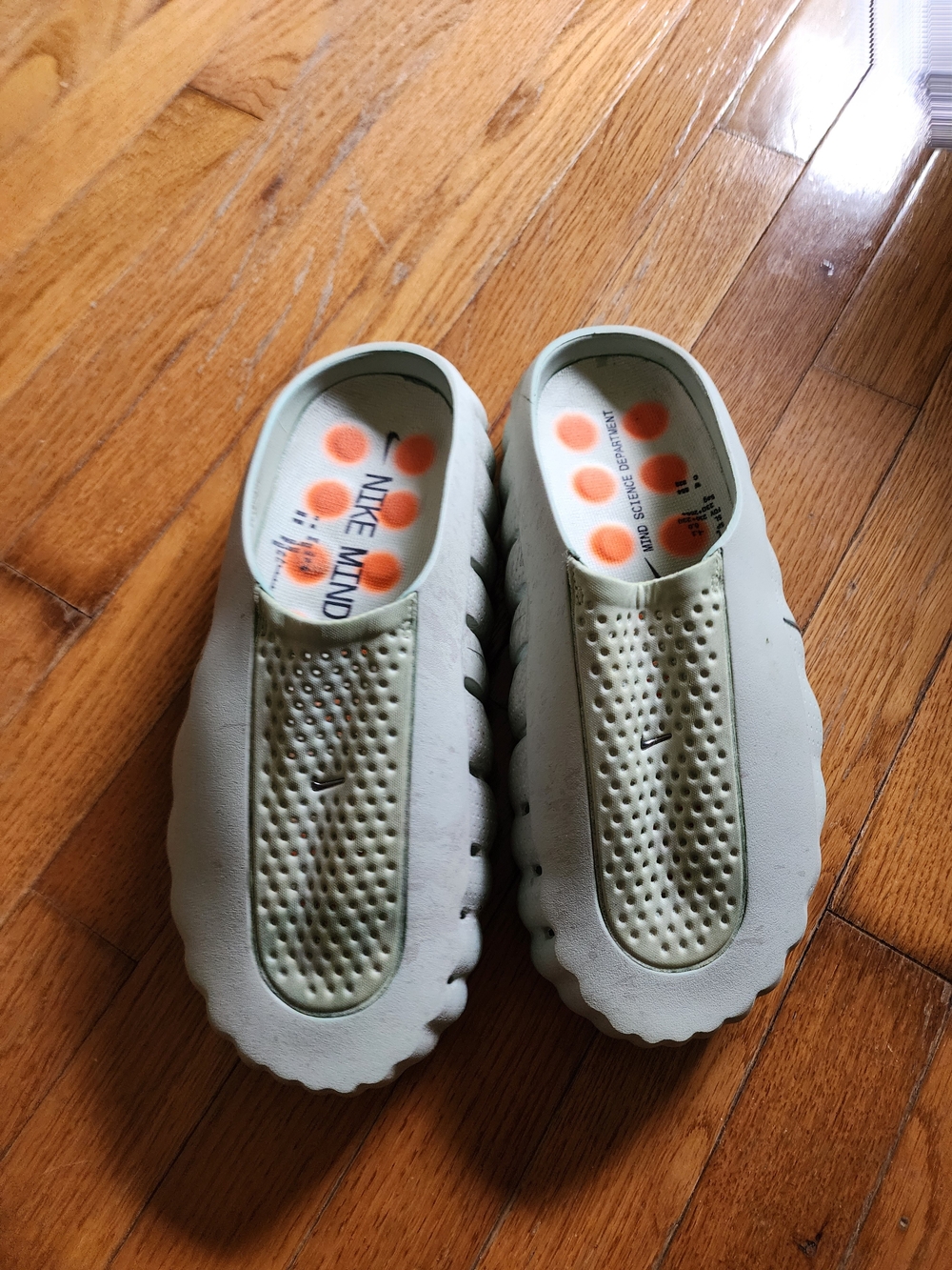 Nike Mind 001 Pregame Mule (also referred to as the Nike Mind Slide Light Olive